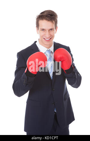 Portrait of happy young woman wearing boxing gloves Banque D'Images