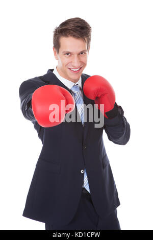 Portrait of happy young woman wearing boxing gloves Banque D'Images
