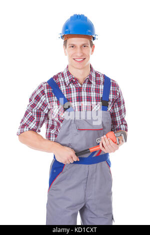 Happy worker holding toolkit et clé sur fond blanc Banque D'Images