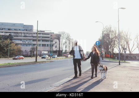 Couple walking with dog Banque D'Images