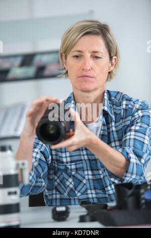 Femme photographe choisir pour le travail de l'appareil photo Banque D'Images