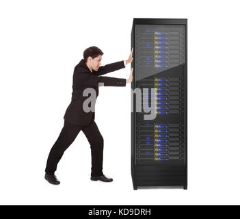 Businessman pushing server rack. Isolated on white Banque D'Images