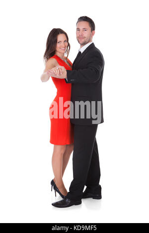 Portrait Of A Happy Couple Dancing on White Background Banque D'Images