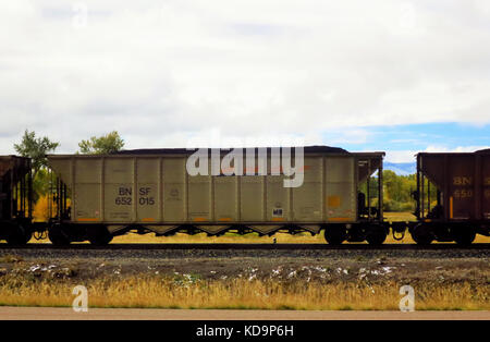 Une cargaison de charbon train dans un champ dans le Montana. Banque D'Images