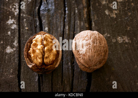Deux écrous, un ouvert et un fermé sur une vieille table en bois Banque D'Images