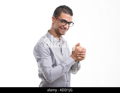 Jeune homme souriant avec joie comme il se frotte les mains en prévision isolated on white Banque D'Images