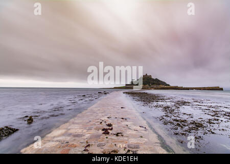 Marazion, Cornwall, UK. 13 octobre 2017. Météo britannique. C'était un léger 17 degrés au lever du soleil ce matin à St Michaels Mount. Les nuages bas ont dominé le ciel que la marée commence à déferler sur l'allée menant à la montagne. Crédit : Simon Maycock/Alamy Live News Banque D'Images