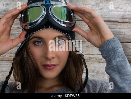 Digital composite of Woman contre le bois avec des lunettes de neige ski Banque D'Images
