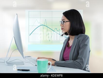 Digital composite of Businesswoman with computer avec schéma graphique Banque D'Images