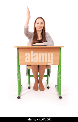 Adolescent school girl raising hand à poser question isolated on white Banque D'Images