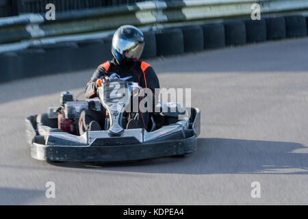 Homme conduisant une voiture en pleine vitesse Go-Kart sur une piste de course Banque D'Images