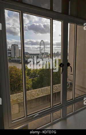 Vue depuis une fenêtre de bureau à Londres, en Angleterre, avec vue sur la Tamise, le Golden Jubilee Bridge et le London Eye. Banque D'Images