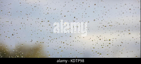 Gouttes de pluie sur la fenêtre floue résumé. Gouttes sur le verre avec l'arrière-plan flou lors de précipitations. Banque D'Images