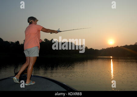 Les poissons pour une femme de son crapet bateau sur le lac Sam Rayburn près de Jasper au Texas Banque D'Images