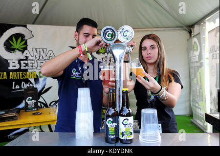 Deux personnes servant des bières de cannabis à un stand au Spannabis, une foire dédiée au cannabis a tenu à Madrid en octobre 2017 Banque D'Images