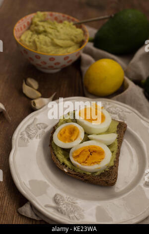 Pain grillé avec sauce à l'avocat et oeuf mollet Banque D'Images