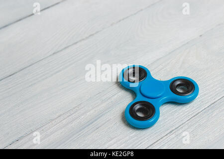 Fidget bleu spinner le jouet sur fond de bois Banque D'Images