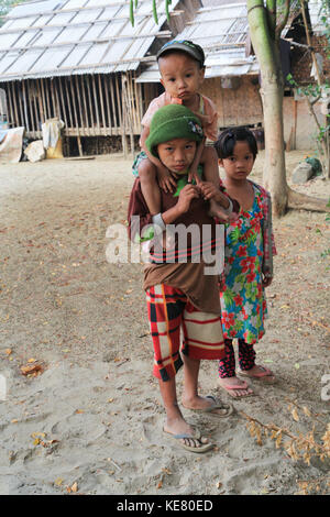 Nyaunghtaw village est sur la gauche (est) de la rivière Irrawaddy dans la province de l'Ayeyarwaddy au Myanmar (Birmanie). boy se greffe autour de son frère. Banque D'Images