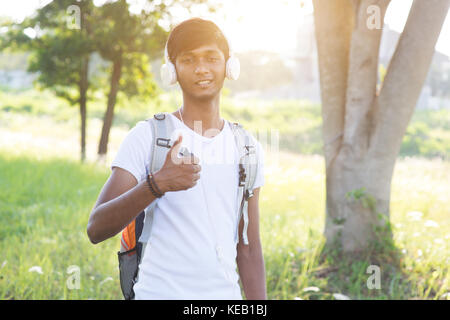 En plein air hommes adolescents indiens d'écouter de la musique Banque D'Images