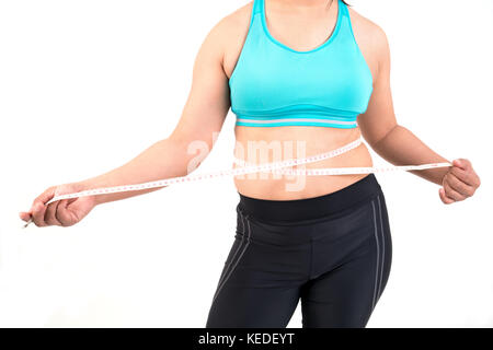 Chubby woman measuring son ventre gras de taille Banque D'Images