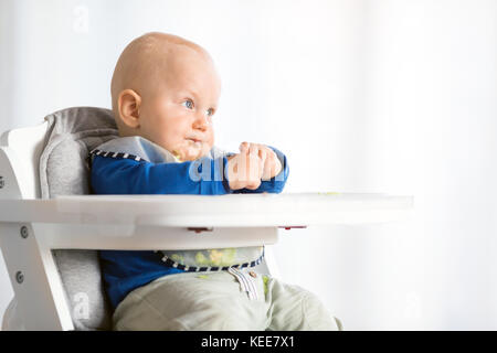 Baby Boy eating bread et concombre avec méthode, BLW led bébé sevrage. Kid végétarien au dîner. Banque D'Images