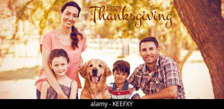 Illustration de joyeux thanksgiving day accueil texte contre portrait of happy family with dog in park Banque D'Images