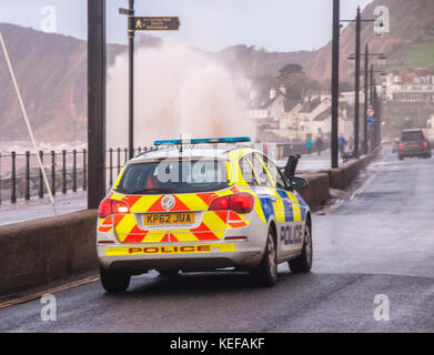 London, UK. 21 Oct 2017. Météo britannique. Patrouille de Police le front que Storm Brian hits Sidmouth, dans le Devon. Par mauvais temps, le grès rouge de la région devient la mer Rouge à Sidmouth. Credit Photo : Alamy/Central Live News Banque D'Images