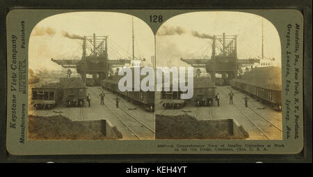 Une vue d'ensemble de petits téléchargeurs au travail sur l'aviron docks, Conneaut, Ohio, par Keystone View Company Banque D'Images