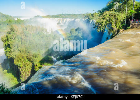 Puerto Iguazu, Argentine - le 19 septembre 2009 : les touristes admirant les puissantes chutes d'Iguazu, et un arc-en-ciel, dans le parc national d'Iguazu à la frontière de Banque D'Images