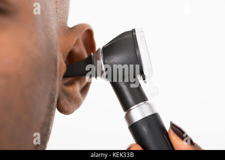 Close-up of doctor examining patient's Ears Banque D'Images