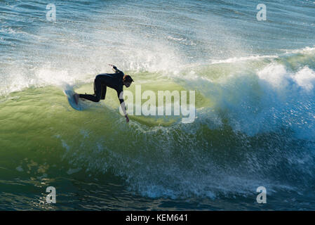 Un conseil rider attraper un vague près de Pismo Pier près de San Luis Obispo, Californie Banque D'Images