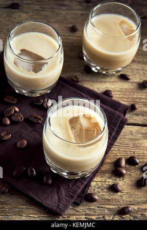 Irish Cream Liqueur de café avec de la glace, bonbons au chocolat et les grains de café sur fond de bois rustique - maison de l'alcool boire festif Banque D'Images