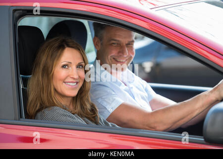 Mature Woman sitting in new car Banque D'Images