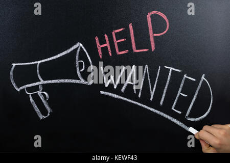 Close-up of help wanted concept écrit sur tableau noir Banque D'Images