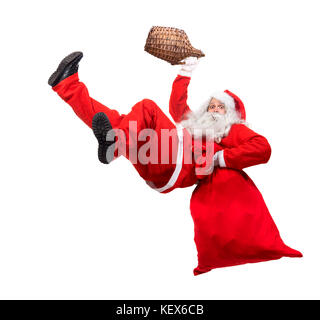 Funny santa claus falls avec un sac rempli de cadeaux. x-mas santa claus est titulaire d'un verre en vase. tomber drunk santa transporter sac avec boîte-cadeau. Banque D'Images