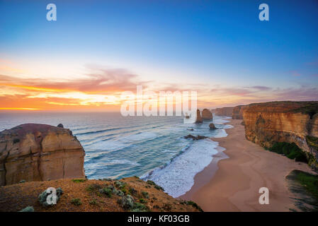 Ciel coucher de soleil spectaculaire à formation rocheuse unique le long d'une côte. Les douze apôtres, Great Ocean Road, Victoria, Australie Banque D'Images