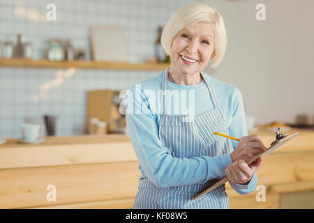 Happy cheerful woman taking notes Banque D'Images