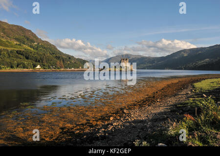 La fin de l'après-midi d'été vue depuis la rive de la mer d'écosse loch alsh de l'ancien château d'Eilean Donan historique dans les west highlands Banque D'Images