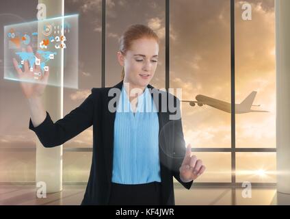 Digital composite de la carte d'interface de l'information et Businesswoman touching air de airplane in airport Banque D'Images