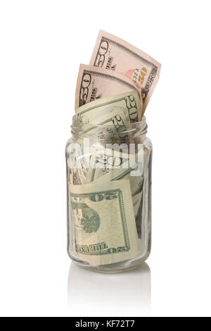 Un petit verre tip jar jar ou don farci de cinquante américains et vingt dollars, sur blanc avec reflet Banque D'Images