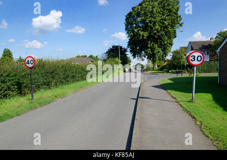 Contraditctory les panneaux de limite de vitesse entrant dans un village (Boughton Monchelsea) dans le Kent, Angleterre Banque D'Images
