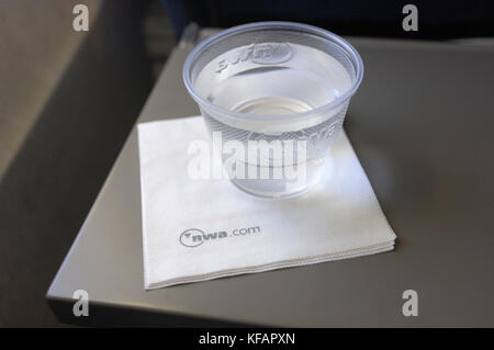 Une tasse en plastique de l'eau potable et une serviette en papier dans la cabine de classe économique sur un Boeing 757-200 de Northwest Airlines mer enroute-MSP numéro du vol NW1 Banque D'Images