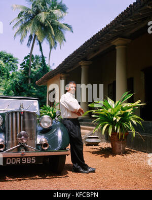 SRI LANKA, l'Asie, Galle, portrait d'un chauffeur standing by vintage car en face de la Dutch House Hotel. Banque D'Images