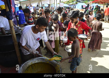 Les enfants réfugiés rohingyas recueille des denrées alimentaires à l'palongkhali camp de fortune à Cox's bazar, au Bangladesh, sur Octobre 06, 2017. D'après l'Organisation des Nat Banque D'Images