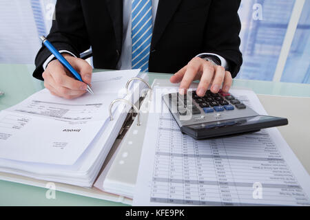 Portrait of young businessman calcul facture au bureau bureau Banque D'Images
