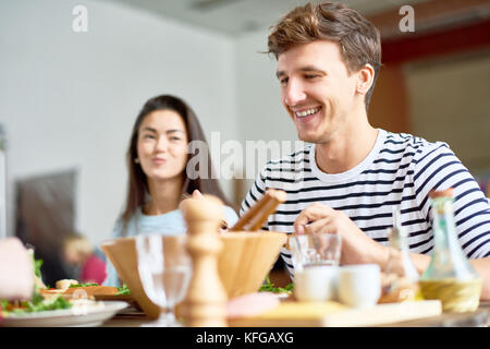 Happy Young Man at Dinner Table Banque D'Images