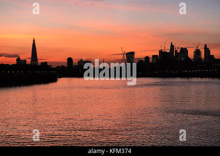 Londres, Royaume-Uni. 30th octobre 2017. Le magnifique coucher de soleil à travers la City de Londres éclairant les bâtiments emblématiques qui ont récemment surgi à Londres et la grande quantité de grues en tour de construction créant encore plus de gratte-ciel. La photo est prise de la rive de la rivière à Canary Wharf. Credit: Nigel Bowles/Alamy Live News Banque D'Images