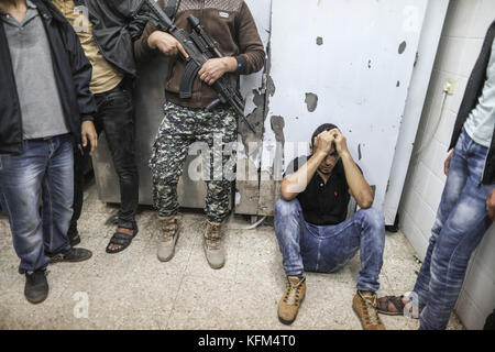 Une personne en deuil réagit près des corps d'hommes tués lorsque les forces israéliennes ont fait sauter un tunnel souterrain s'étendant de la bande de Gaza à son territoire, à Deir al-Balah, dans la bande de Gaza, le 30 octobre 2017. Photo : Wissam Nassar/dpa Banque D'Images