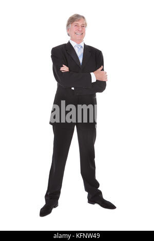 Portrait Of Happy young woman with Hand in Pocket sur fond blanc Banque D'Images