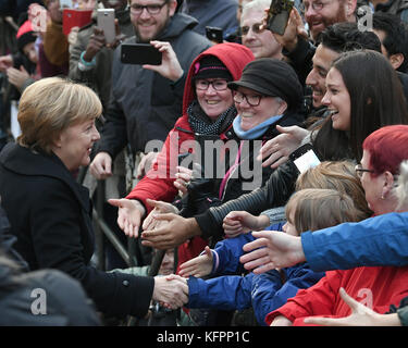 Wittenberg, Allemagne. 31 octobre 2017. La chancelière allemande Angela Merkel (CDU, l) avec des membres du public, après un service religieux marquant le 500e anniversaire du début de la réforme, devant la Schlosskirche (église du château) à Wittenberg, Allemagne, le 31 octobre 2017. Crédit : dpa Picture alliance/Alamy Live News Banque D'Images